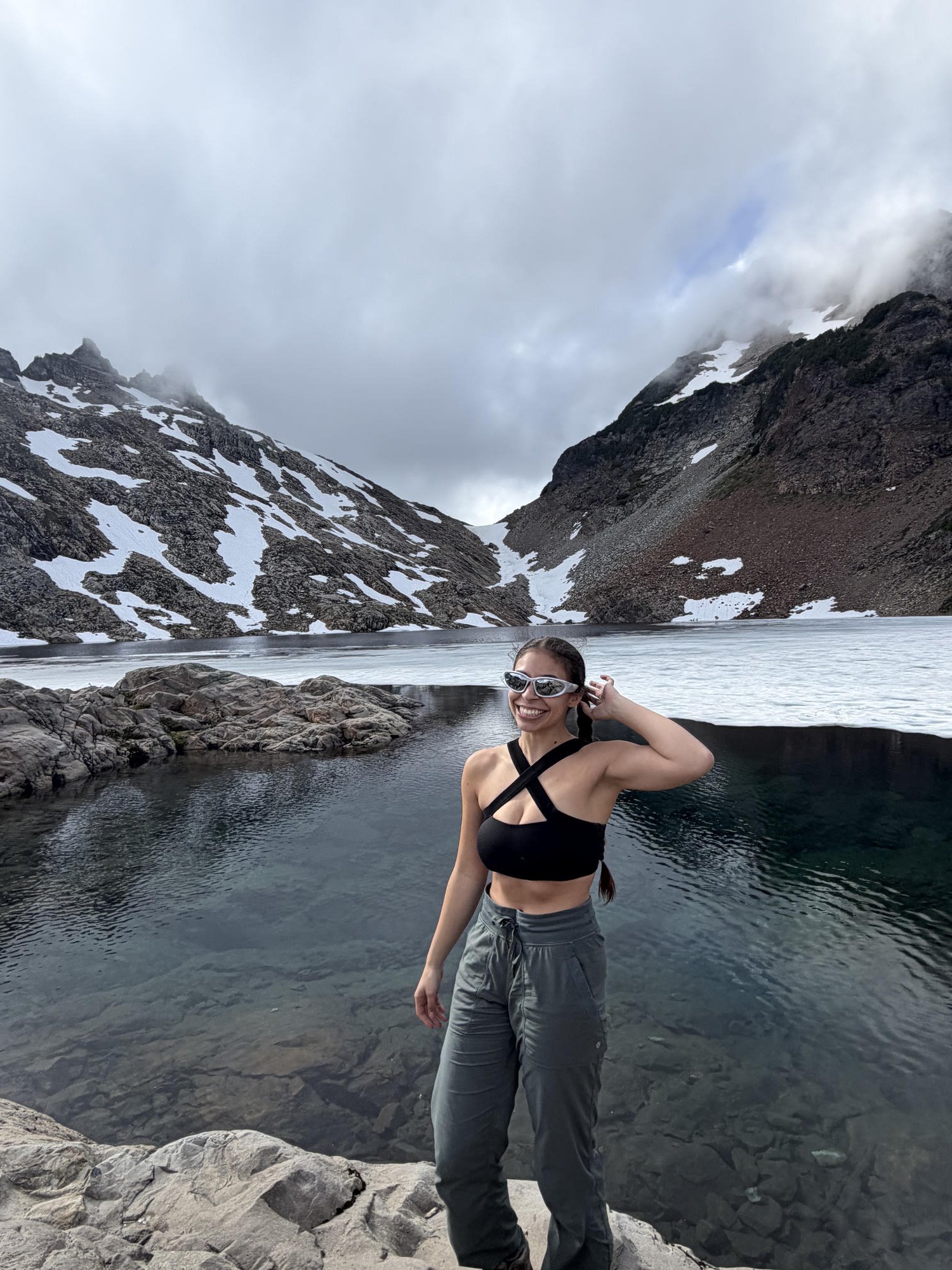 Standing at the edge of the still partly-frozen Foggy Lake with snow-streaked peaks behind